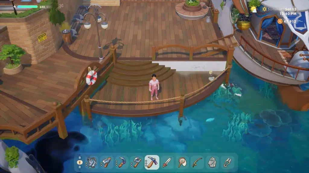Dock area in Coral Island game with a character standing on the wooden pier.