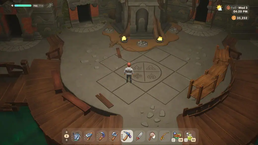 A character stands in a circular area inside a rustic, medieval-style hall with benches and a firepl.